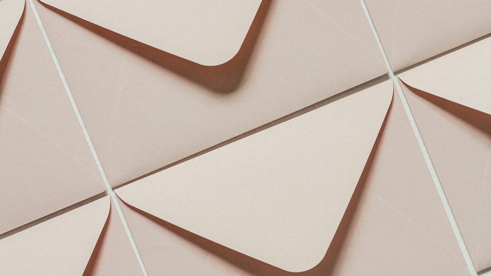 Blush pink stationery on a neutral surface