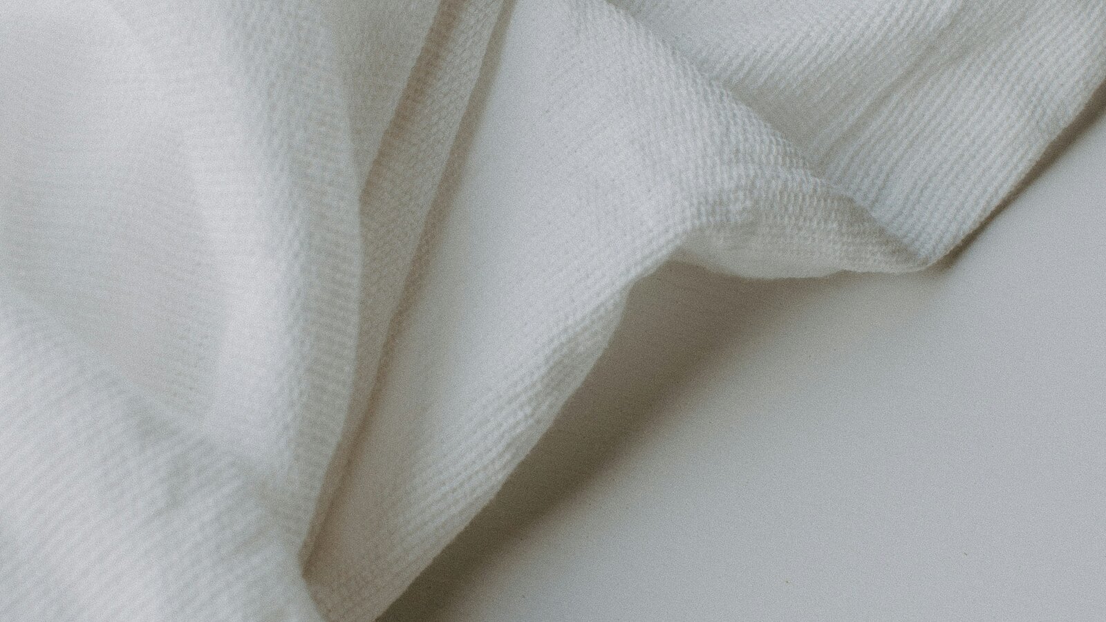 Calm neutral folded linen in soft daylight